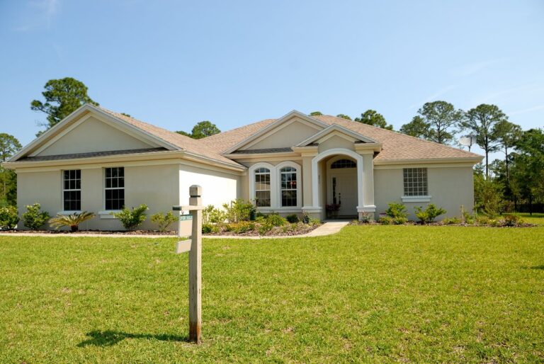 Single-story house with a for-sale sign, illustrating how to calculate debt to income ratio for a mortgage